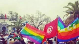 Demonstrators raising Tunisian and Rainbow flags during a march at the World Social Forum 2015 in Tunisia